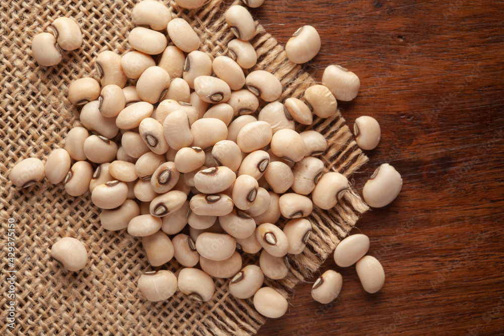 Macro Close-up of Organic Soybean (Glycine max) or Soya bean dal on Jute mat and wooden top. Macro Close-up of Organic Soybean (Glycine max) or Soya bean dal on Jute mat and wooden top.