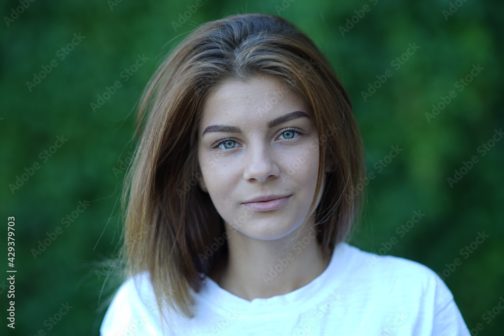 Portrait of a young beautiful girl in the park