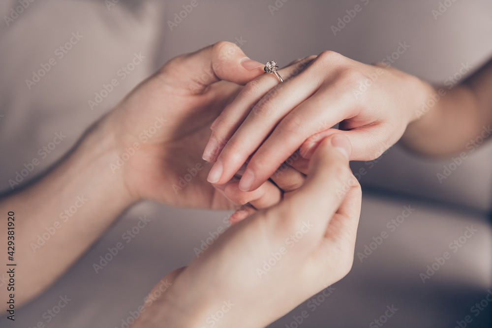 Cropped close-up view of hands girl receiving ring from guy fiance propose moment finger at home indoors Cropped close-up view of hands girl receiving ring from guy fiance propose moment finger at home indoors