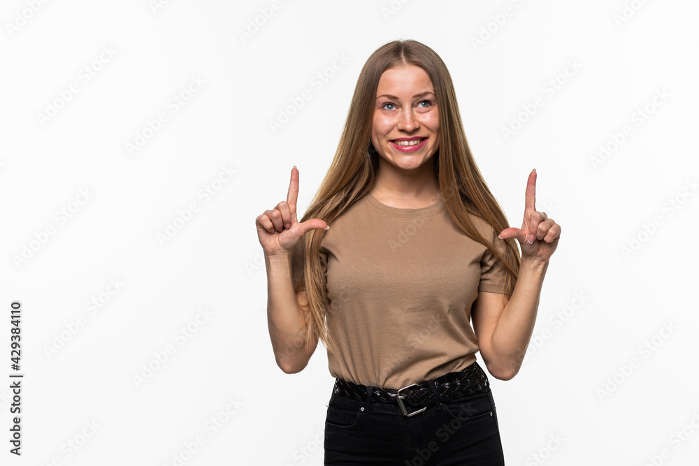 Happy young woman pointing up with both hands isolated on a white background Happy young woman pointing up with both hands isolated on a white background