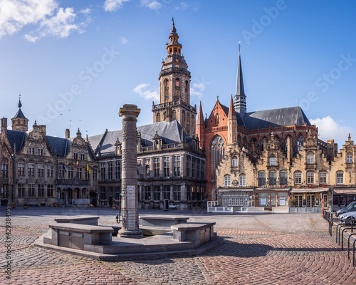 Veurne, West Flanders, Belgium - 04 06 2021: View of the market square (Grote Markt), the city hall, the belfry, and the church of Saint Walburga