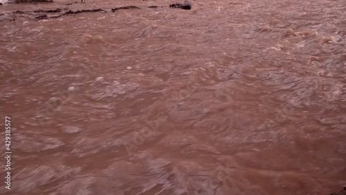 The river is red. The concept of contamination of running water with iron oxide, manganese, or potassium rhodanide photo