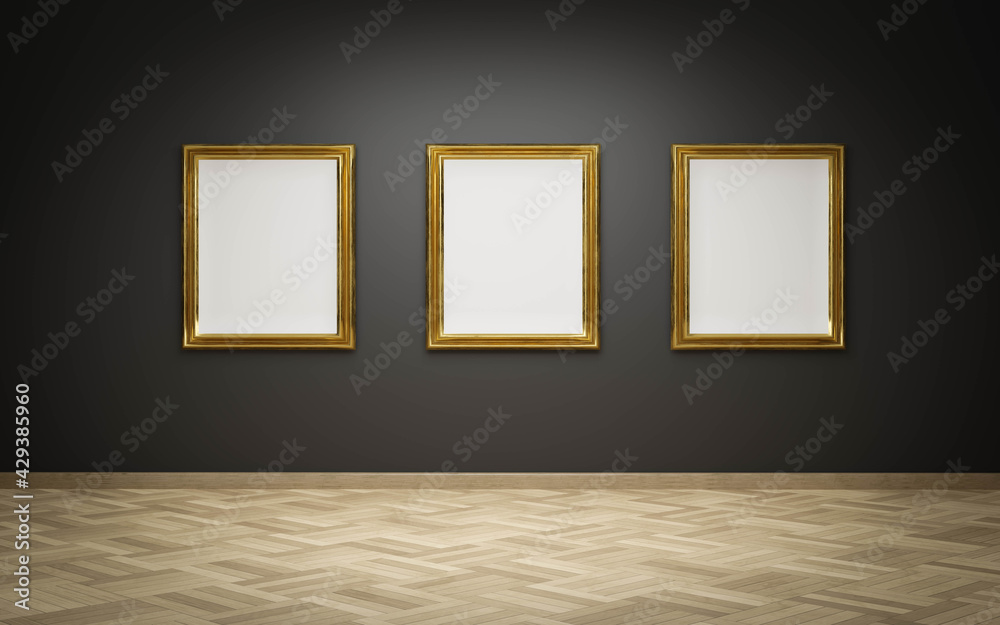empty golden picture frames with blank canvas on black wall in art ...