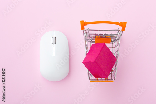 Click and collect concept on pastel pink background photo