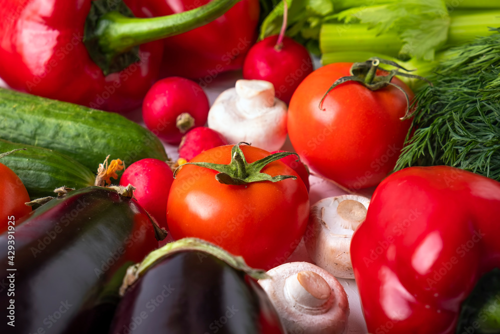 Fresh vegetables background - tomatoes, zucchini, mushrooms, radish, cucumbers, greens Fresh vegetables background - tomatoes, zucchini, mushrooms, radish, cucumbers, greens