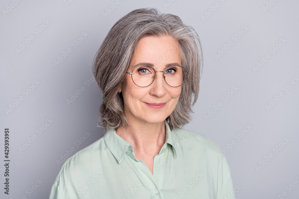 Photo of happy positive smiling pretty sweet grandmother wear glasses and green shirt isolated on grey color background