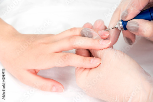 Close-up of female hands during a manicure procedure in the salon.