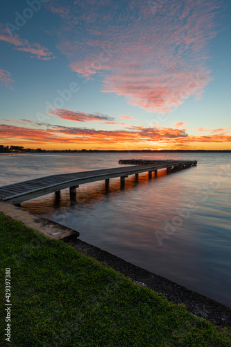 Sunset view of the jetty in the lake. © AlexandraDaryl
