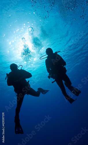 Silhouette of scuba diver in the blue ocean