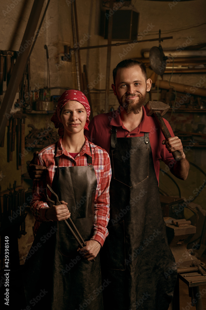 blacksmiths couple with tools in smithy portrait blacksmiths couple with tools in smithy portrait