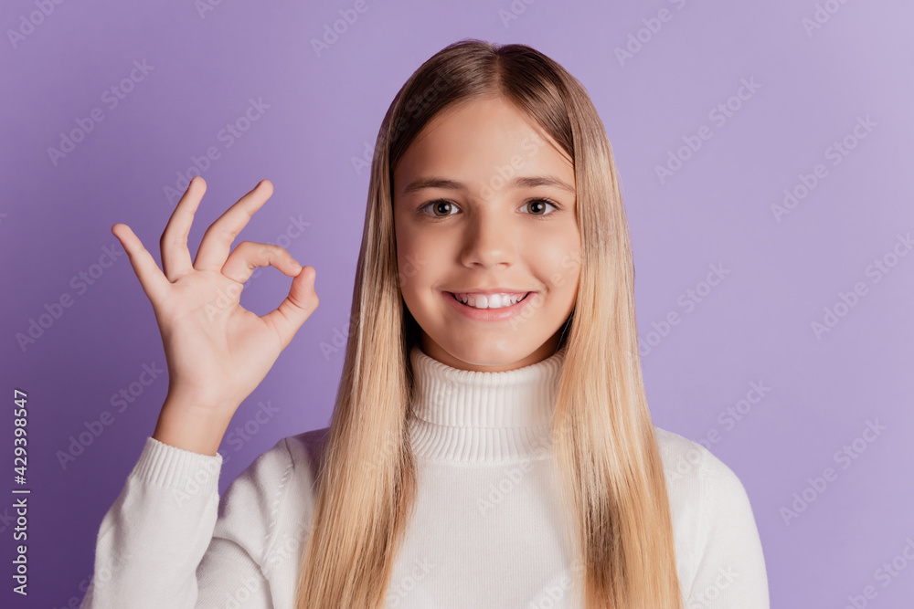 Photo of cheerful lady show okey gesture wear white jumper posing on violet background