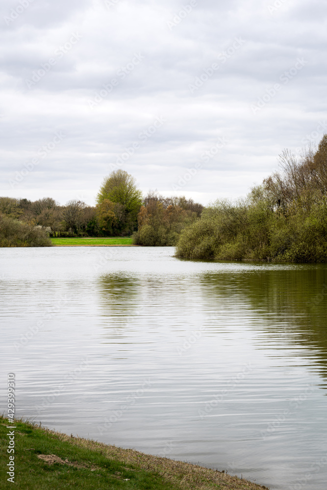View of Bewl water, walking around the reservoir in South East England on a cloudy spring afternoon