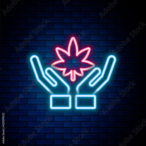 Glowing neon line Medical marijuana or cannabis leaf icon isolated on brick wall background. Hemp symbol. Colorful outline concept. Vector