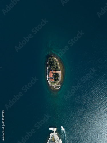 Aerial view of Island of Saint George (Sveti Dorde) with monastery off the coast of Perast in the Bay of Kotor (Boka Kotorska ) Montenegro. Small island in Adriatic sea from drone. Popular landmark.