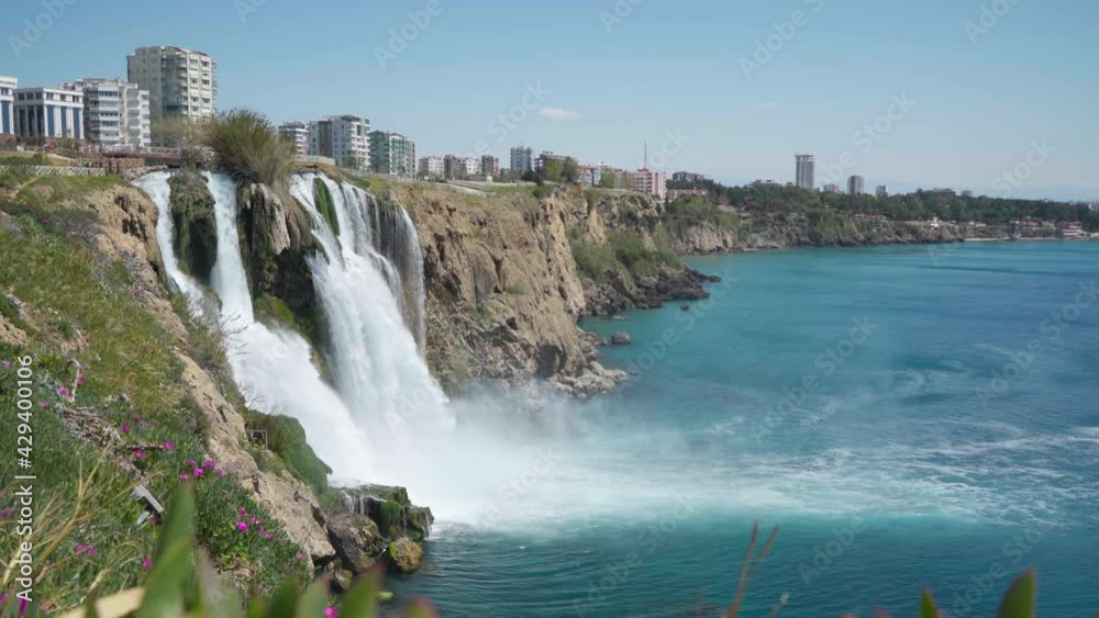 Lower Düden Falls drop off a rocky cliff falling from about 40 m into the Mediterranean Sea in amazing water clouds 4k footage. Antalya, Turkey. Lower Düden Falls drop off a rocky cliff falling from about 40 m into the Mediterranean Sea in amazing water clouds 4k footage. Antalya, Turkey.