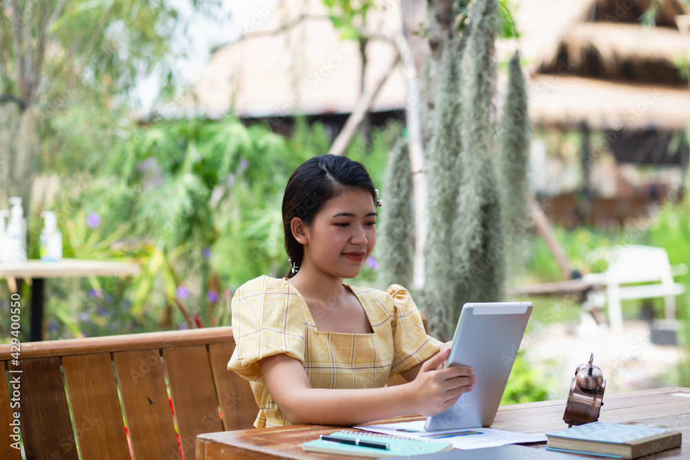 A happy businesswoman because she saw the profits shown in her tablet. A happy businesswoman because she saw the profits shown in her tablet.