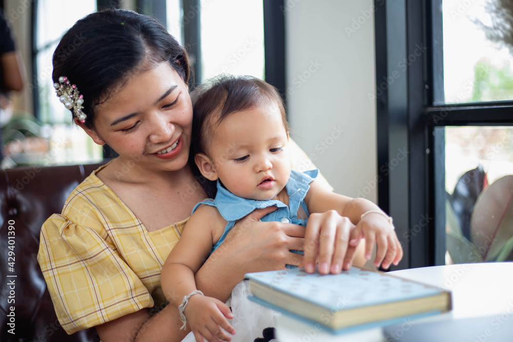 Mother and daughter relax and read a book Mother and daughter relax and read a book