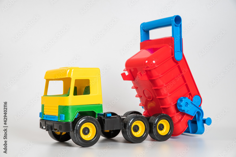 Multi-colored plastic children's toy cars on a white background. Truck. Multi-colored plastic children's toy cars on a white background. Truck.