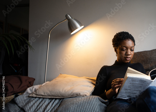 Woman reading a book from her comfortable sofa