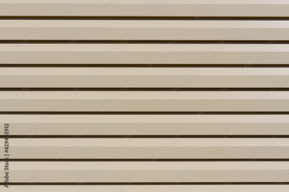 Metallic siding panel background. Siding board backdrop in residential housing wall. Metallic siding panel background. Siding board backdrop in residential housing wall.