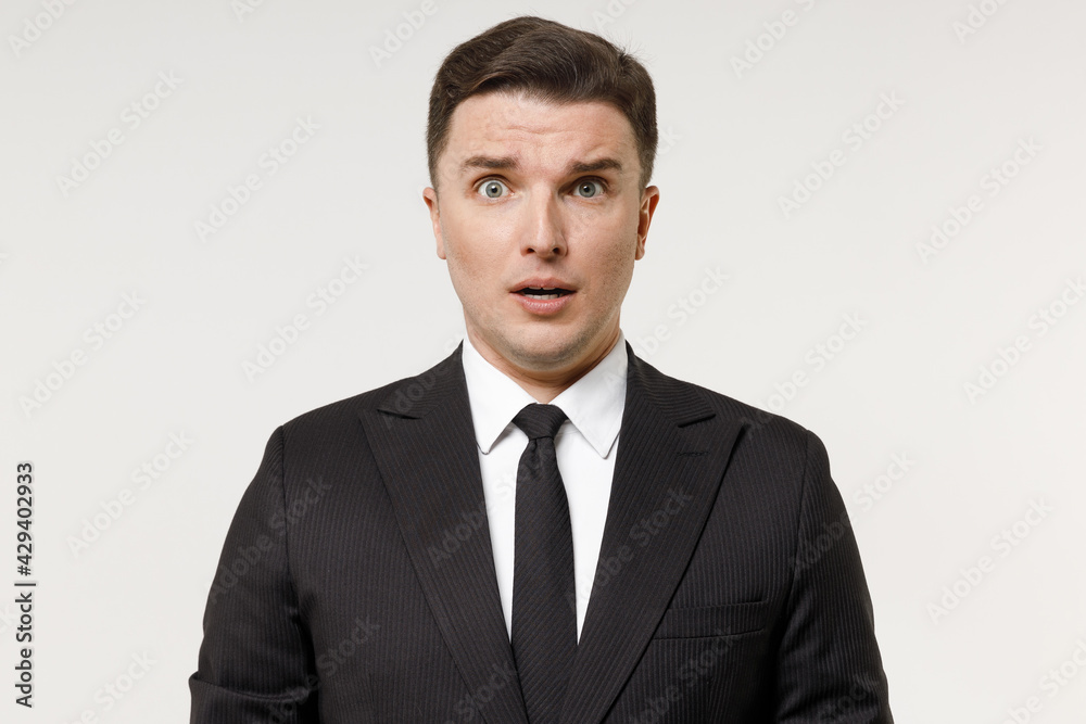 Close up young shocked employee business corporate lawyer man 20s in classic formal black grey suit shirt tie work in office look camera with open mouth isolated on white background studio portrait Close up young shocked employee business corporate lawyer man 20s in classic formal black grey suit shirt tie work in office look camera with open mouth isolated on white background studio portrait