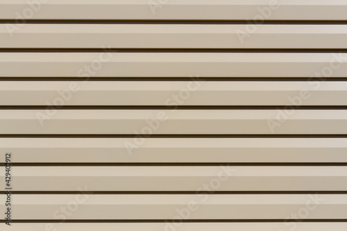 Metallic siding panel background. Siding board backdrop in residential housing wall.