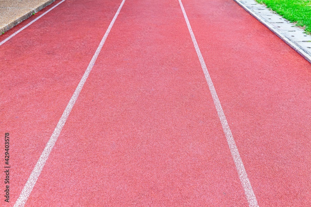 Red rubber running track flooring texture and background