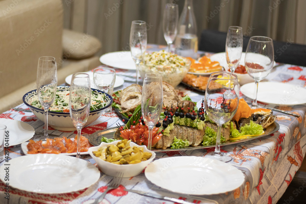A beautiful served table for a holiday with a dish of baked fish.