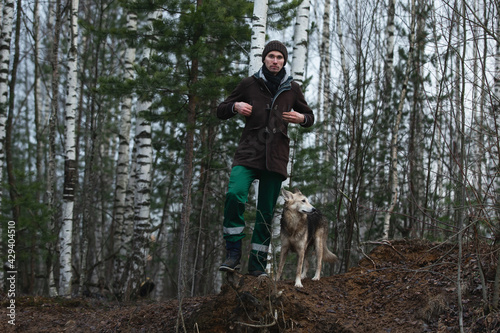 Owner standing with mixed breed dog at atutumn meadow © Alexandr