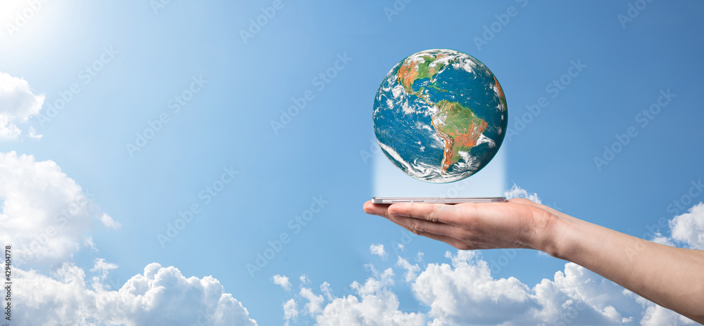 Hands holding a planet, earth on a background of nature blue sky with beautiful white clouds and sunlight.Sustain earth concept. Elements of this image furnished by NASA Hands holding a planet, earth on a background of nature blue sky with beautiful white clouds and sunlight.Sustain earth concept. Elements of this image furnished by NASA