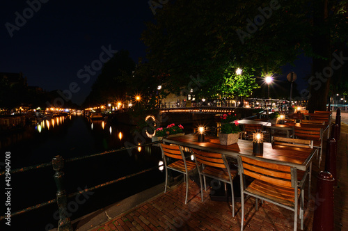 A night in Amsterdam. Light streaks of a boat flowing down the canal. Summer. Night.
