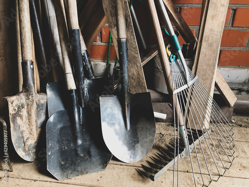 Garden tools in the barn, shovels, rakes.