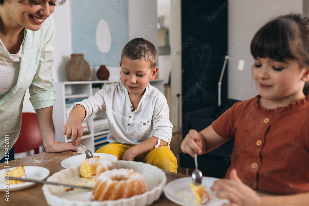 kids and mother eating cake at home kids and mother eating cake at home