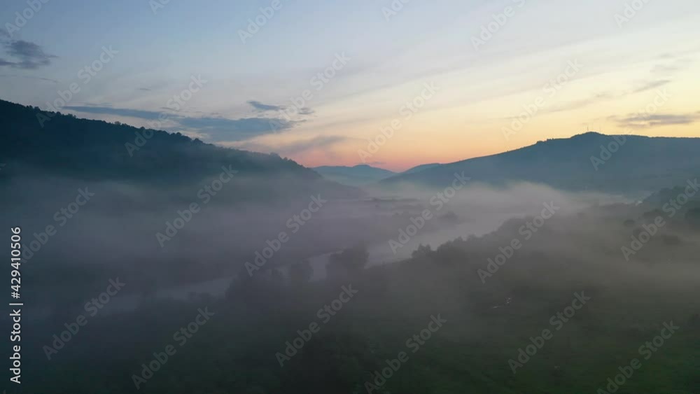 Fog over the river in the mountain valley. Landscape during sunset. View from the air. Summer landscape with river and fog. Fog over the river in the mountain valley. Landscape during sunset. View from the air. Summer landscape with river and fog.