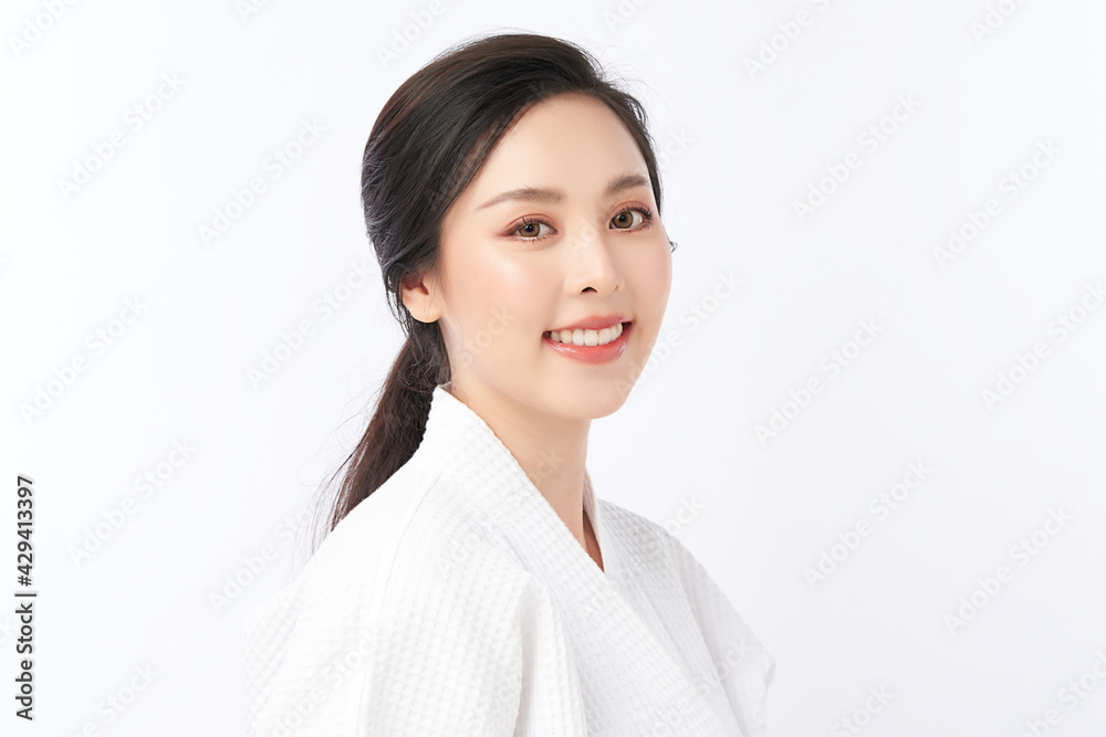 Beautiful young Asian woman wearing bathrobe on white background, Face care, Facial treatment, Cosmetology, beauty and spa Concept. Beautiful young Asian woman wearing bathrobe on white background, Face care, Facial treatment, Cosmetology, beauty and spa Concept.