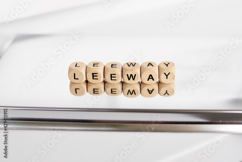 Word leeway made by wooden cubes with reflection