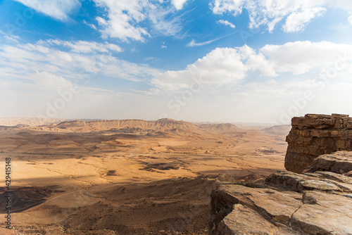 Ramon Crater Makhtesh Ramon, the largest in the world, as seen from the high rocky cliff edge surrounding it from the north, Ramon Nature reserve, Mitzpe Ramon, Negev desert, Israel. High quality photo