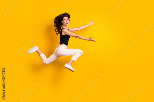 Full length body size side profile photo of woman running fast on meeting cheerful missed friends isolated bright yellow color background