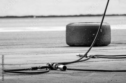 Grayscale of a wheel gun for the motor racing championship on the road photo