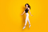 Full length body size photo of funny woman jumping up gracefully like ballerina isolated on bright yellow color background