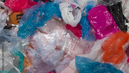 Collection and Disposal of Packaging Plastic. Loop. Various types of used plastic bags and packaging rotate slowly in front of the camera to symbolize sorting and recycling