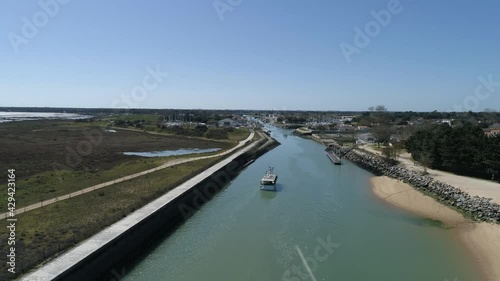 Wallpaper Mural Small fishing boat entering harbor at Boyardville in Oleron island France from canal, Aerial flyover shot Torontodigital.ca