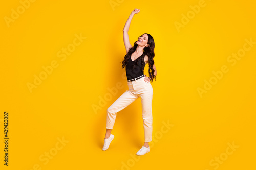 Full size photo of young attractive gorgeous woman happy positive smile wear casual outfit isolated over yellow color background