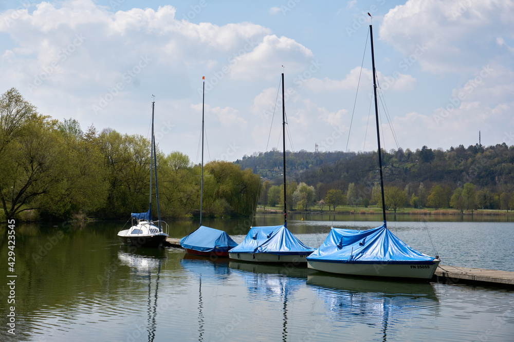 blue and white boats on the beautiful Max-Eyth-See lake under blue sky in sunshine