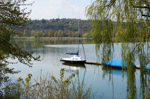 blue and white boats on the beautiful Max-Eyth-See lake under blue sky in sunshine