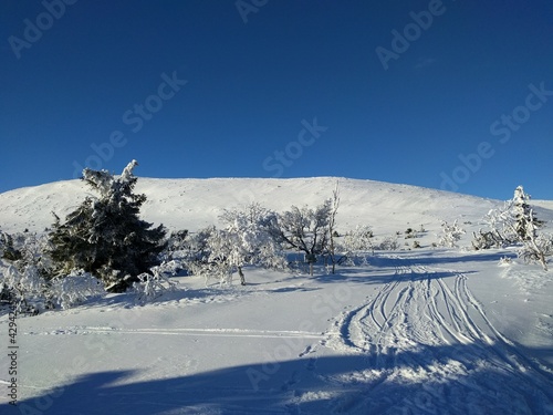 ski track in the mountains with sun and blue sky