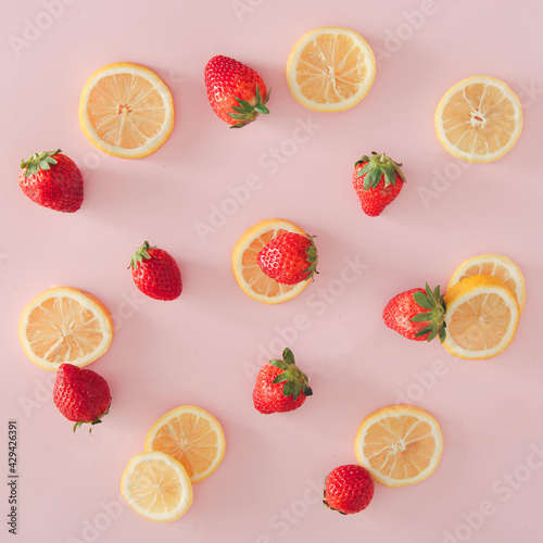 Fototapeta Naklejka Na Ścianę i Meble -  Delicate flat lay background. Lemon and strawberries on  pastel pink background.