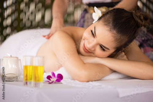 Beautiful young asian girl resting relaxing oil massage in spa resort with closed eyes.