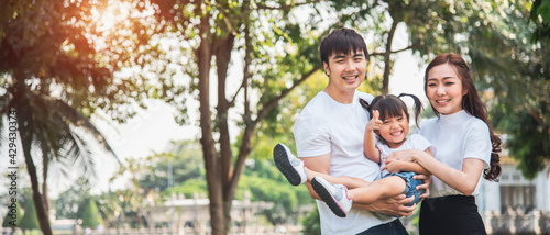 Banner photo of young happy Asian family in garden. Asian family and happy family concept