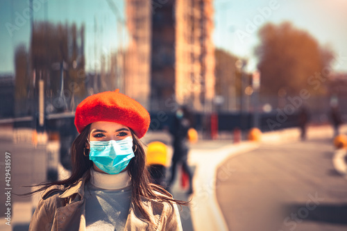 Girl with medical mask is walking in the city during pandemic of Coronavirus Covid-19